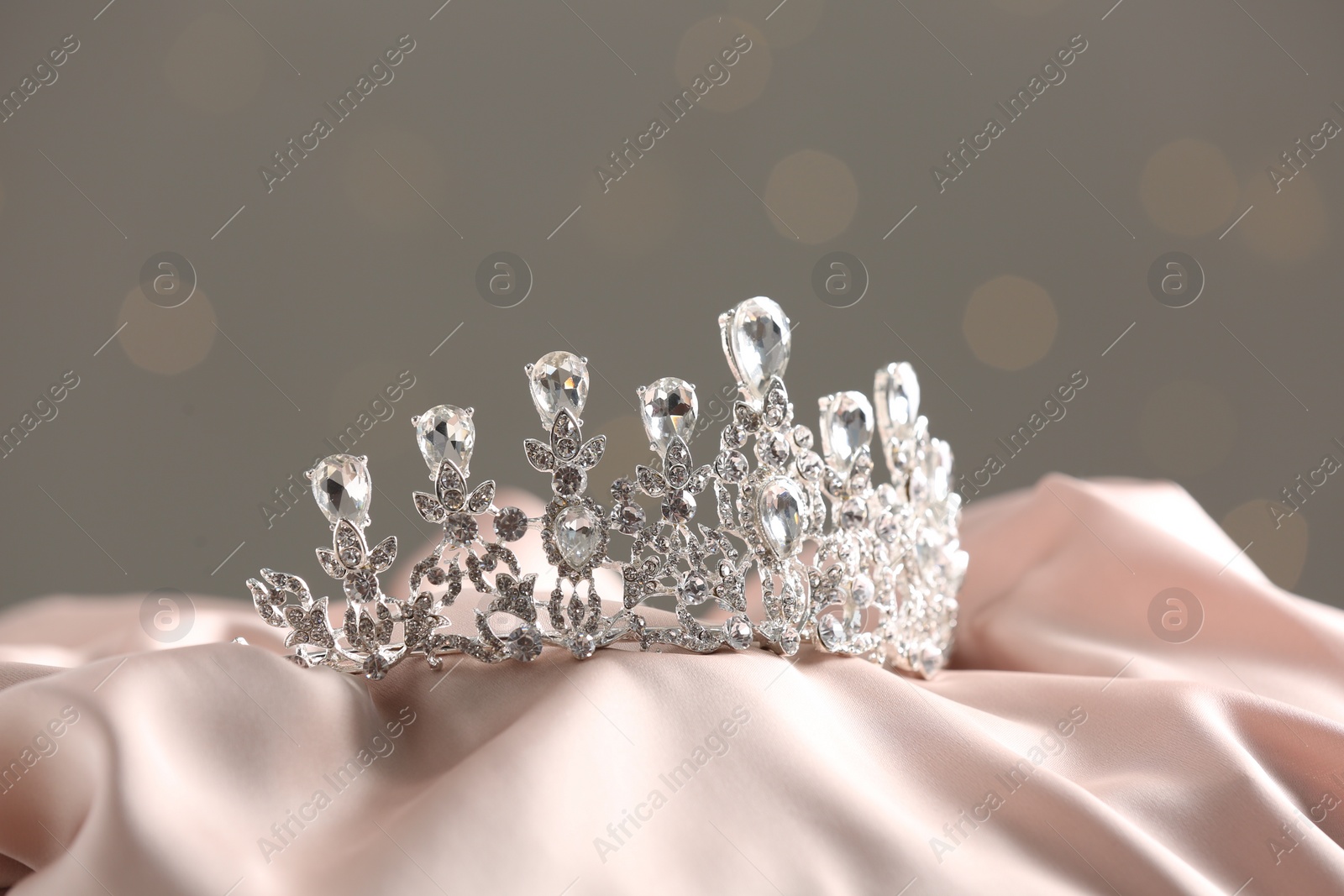 Photo of Beautiful silver tiara with diamonds on light cloth