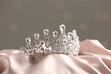 Beautiful silver tiara with diamonds on light cloth