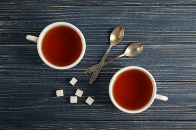 Photo of Flat lay composition with delicious tea on wooden background