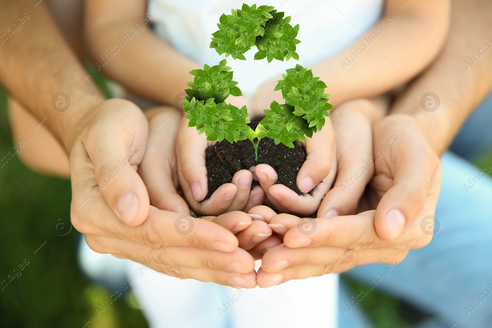 Image of Family holding fertile soil in hands on blurred background and recycling symbol, closeup