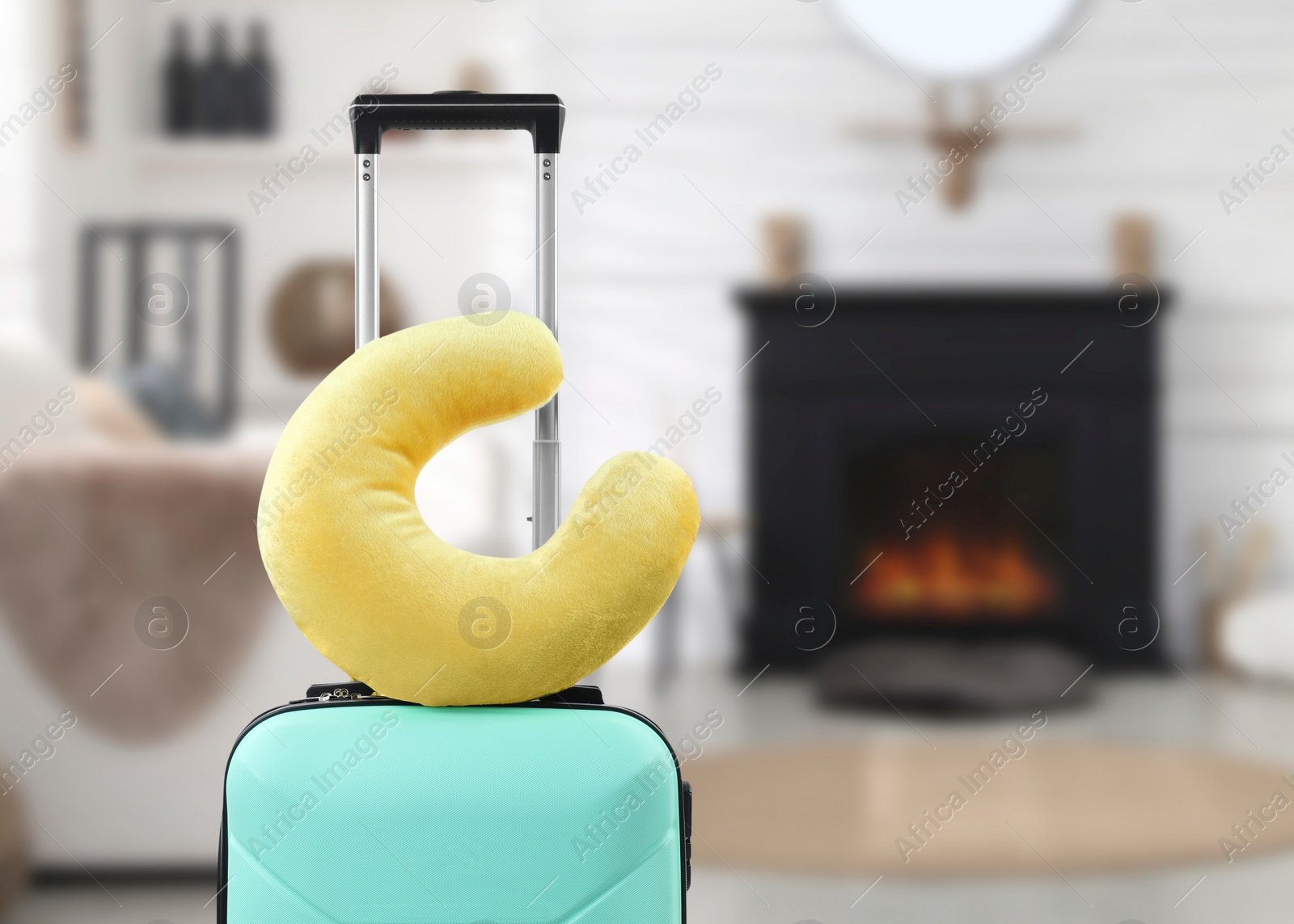 Image of Travel pillow on suitcase in room. Space for text