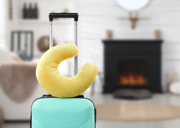 Image of Travel pillow on suitcase in room. Space for text