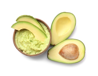 Bowl with guacamole and ripe avocado on white background, top view