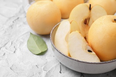 Delicious apple pears on white textured table, closeup. Space for text