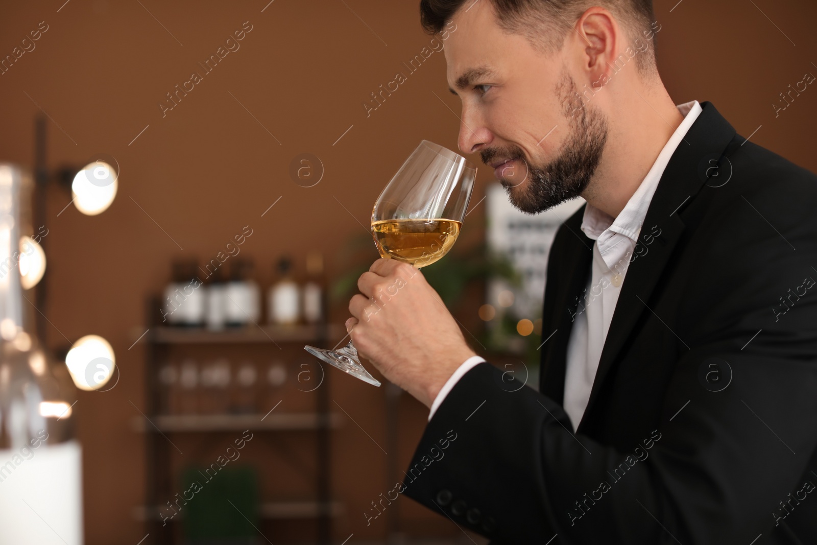 Photo of Young man with glass of wine indoors