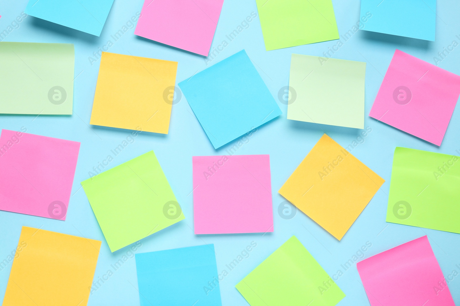 Photo of Blank colorful sticky notes on turquoise background, flat lay. Space for text