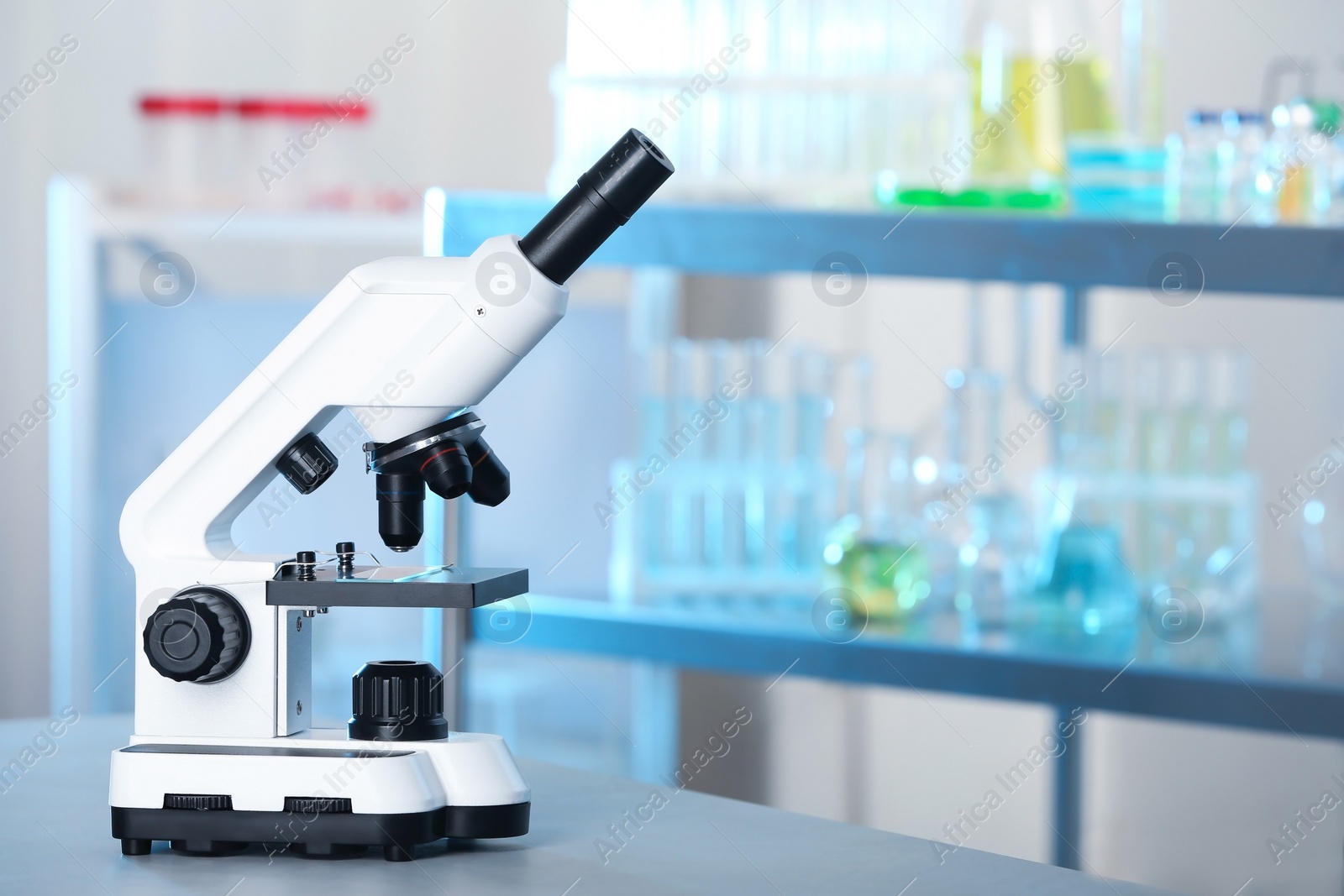 Photo of Modern microscope on table in laboratory. Chemical analysis