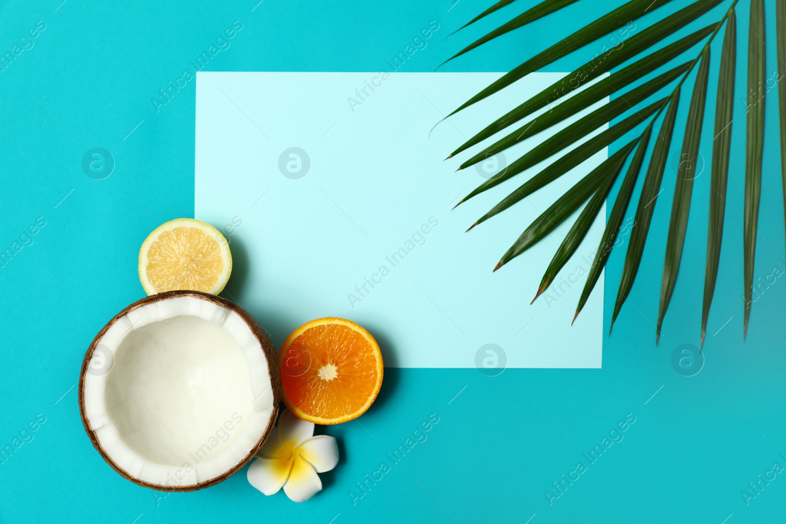 Photo of Flat lay composition with fresh coconut half on blue background. Space for text