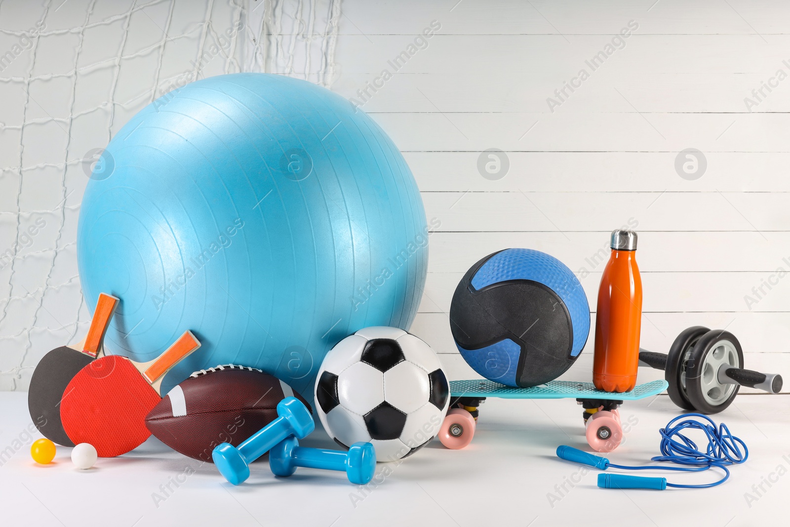 Photo of Many different sports equipment on white table