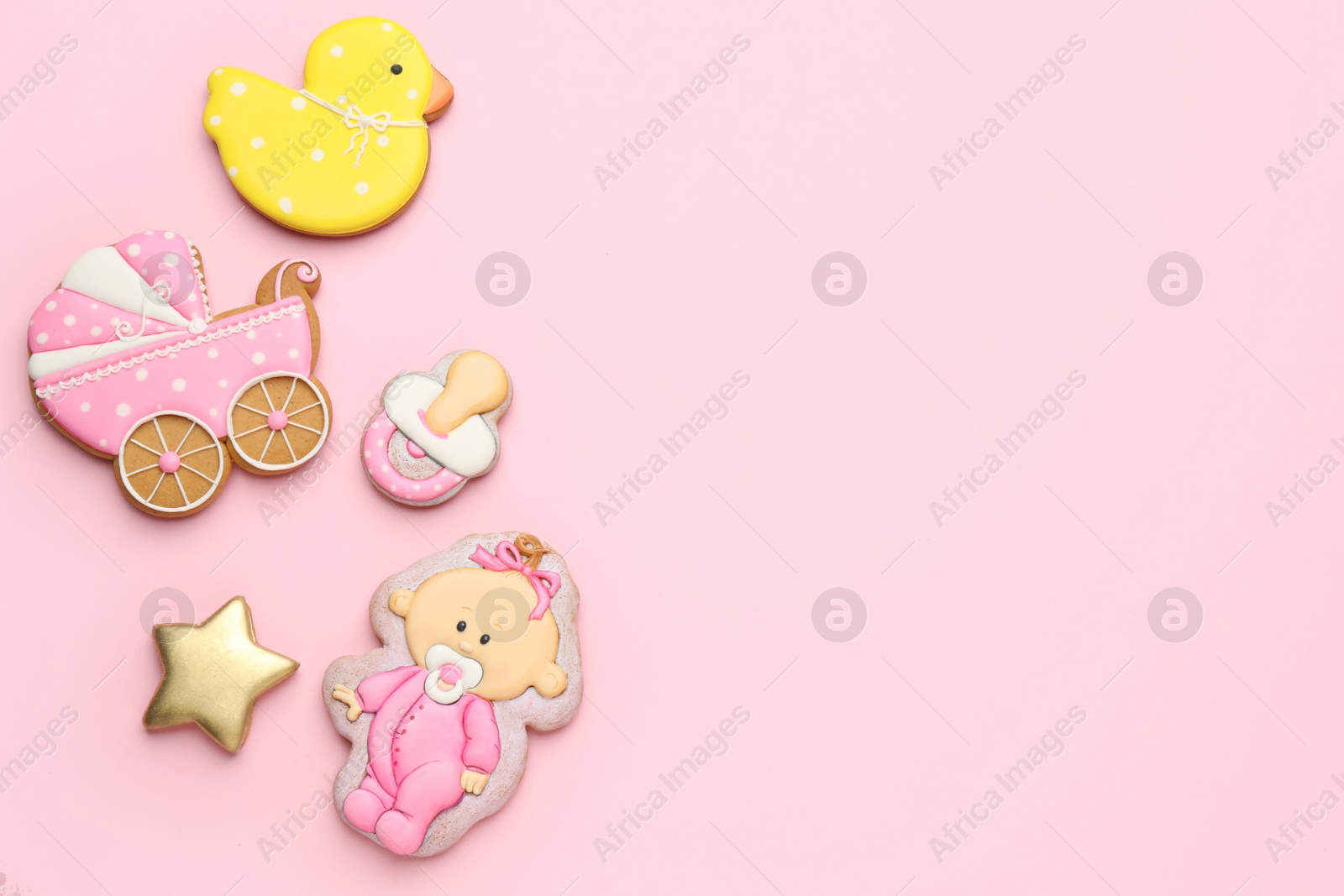 Photo of Cute tasty cookies of different shapes on pink background, flat lay with space for text. Baby shower party