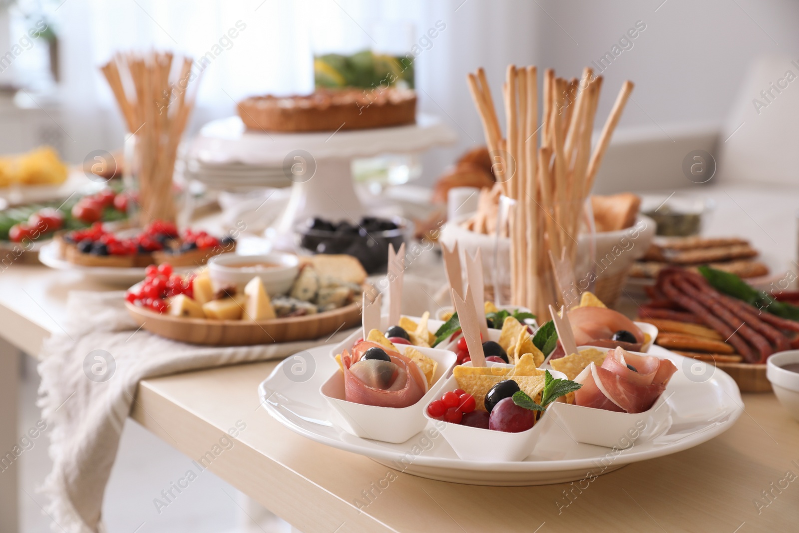 Photo of Dishes with different food on table in room. Luxury brunch