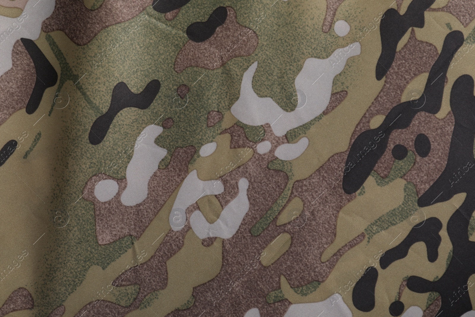 Photo of Texture of camouflage fabric as background, top view