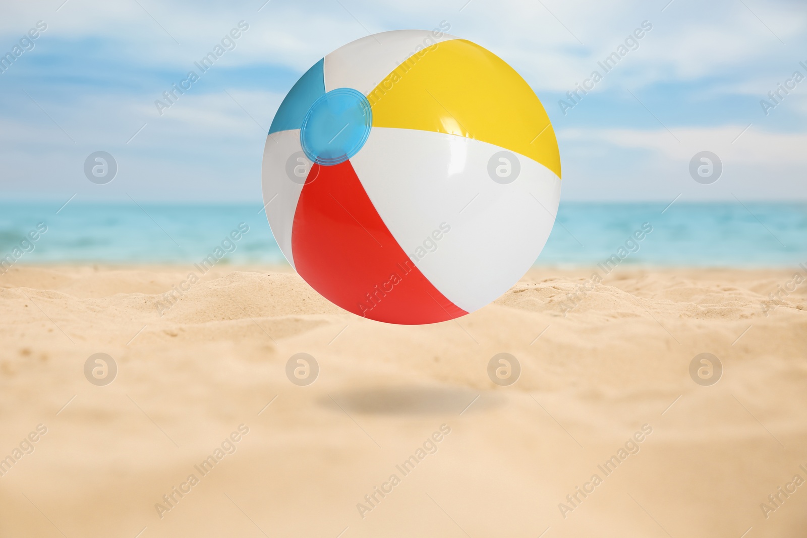 Image of Colorful inflatable beach ball and seascape on background