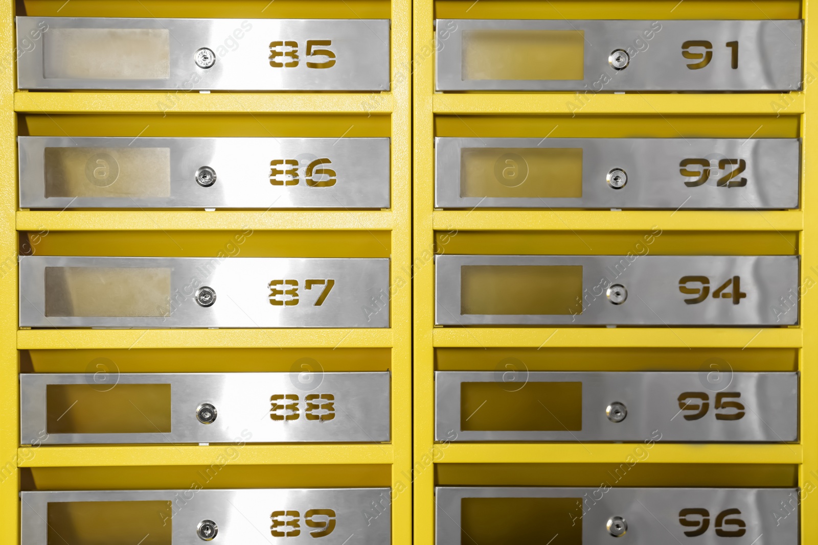 Photo of Many closed metal mailboxes with keyholes and numbers as background