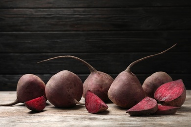 Photo of Ripe beets on table against black background