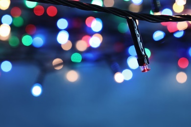 Beautiful Christmas lights on color background, closeup