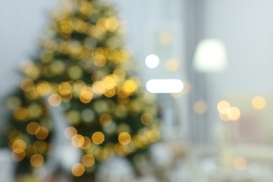 Blurred view of Christmas tree and festive decor in room. Interior design