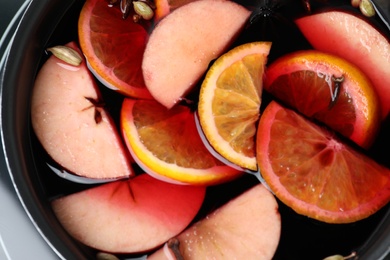 Photo of Delicious hot mulled wine in pot, top view