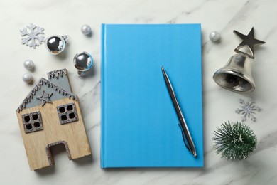 Stylish planner and Christmas decor on white marble background, flat lay. New Year aims