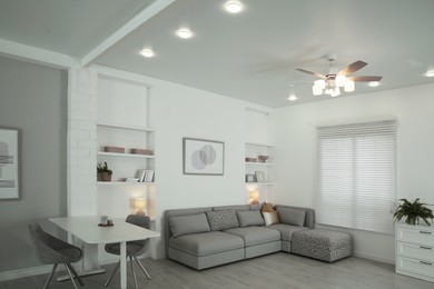 Photo of Ceiling fan, furniture and accessories in stylish living room