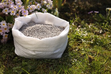 Fertilizer in bag on green grass outdoors