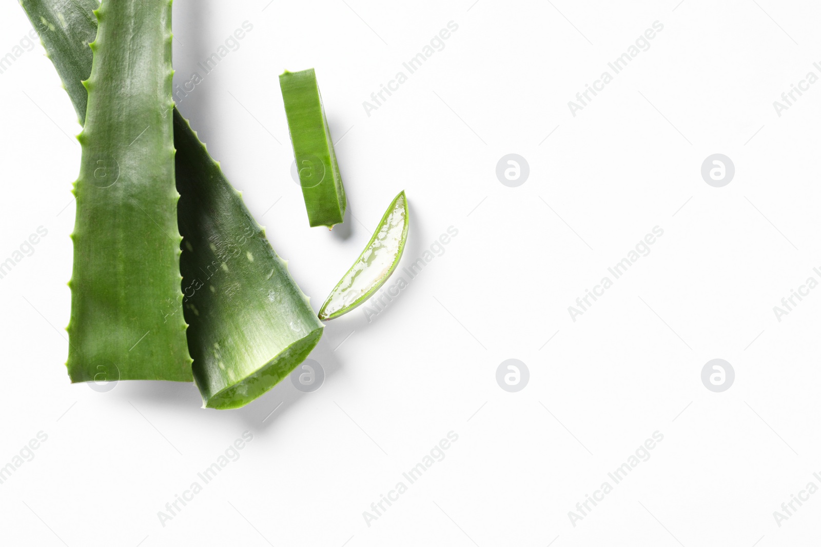 Photo of Cut aloe vera plant on white background, flat lay. Space for text