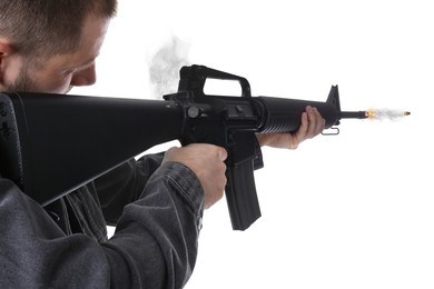Image of Man shooting from assault rifle on white background, closeup