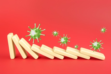 Image of Concept of spreading coronavirus. Wooden domino tiles falling on red background