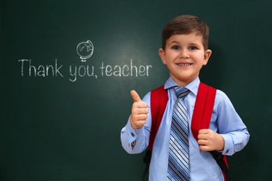 Image of Cute little boy near chalkboard with phrase Thank You Teacher