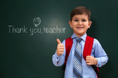 Cute little boy near chalkboard with phrase Thank You Teacher