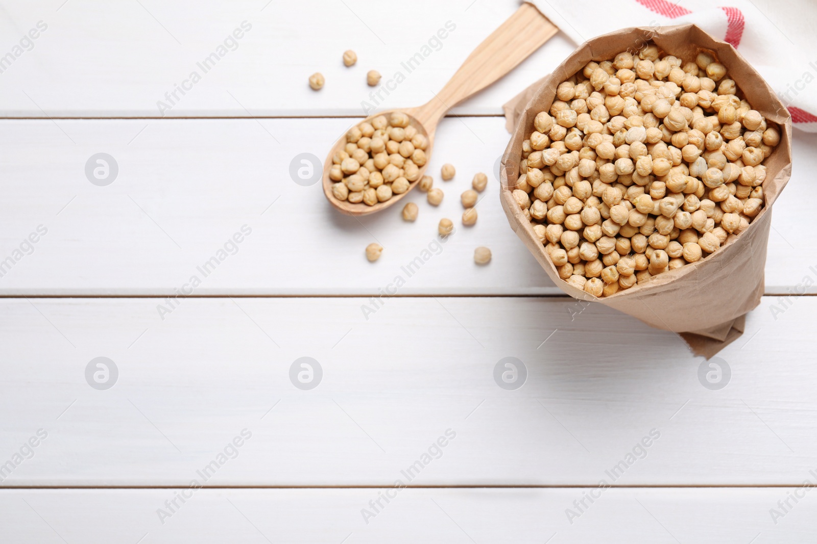 Photo of Chickpeas on white wooden table, flat lay. Space for text