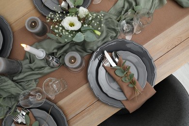 Photo of Festive table setting with beautiful floral decor indoors, flat lay