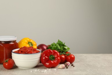 Delicious lecho and fresh ingredients on light grey table. Space for text