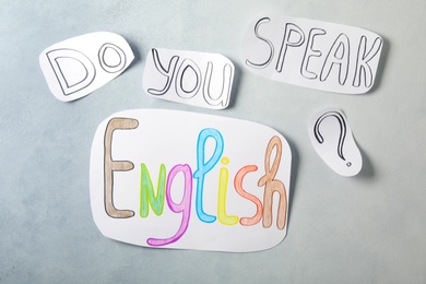 Photo of Question DO YOU SPEAK ENGLISH? on light grey background, flat lay