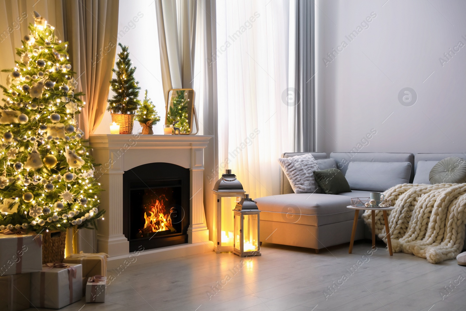 Photo of Stylish living room interior with beautiful fireplace, Christmas tree and other decorations