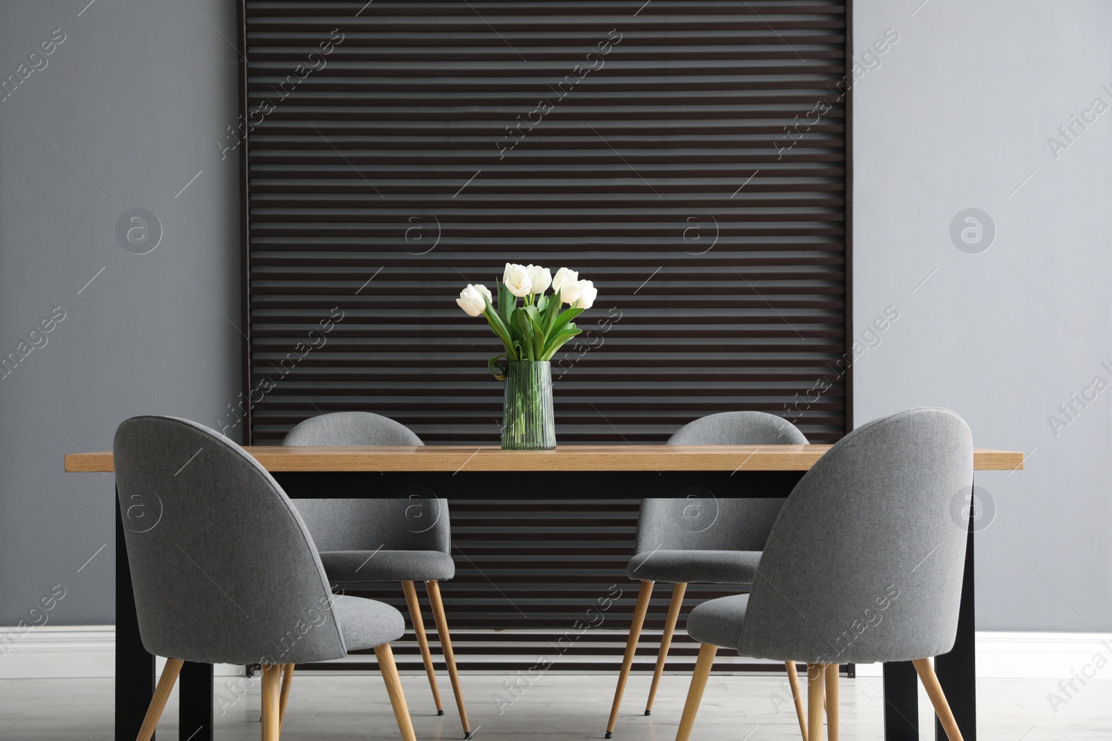 Photo of Table and chairs in room. Stylish interior design