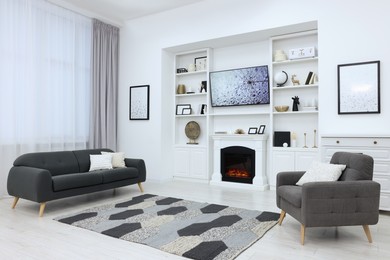 Stylish room with beautiful fireplace and comfortable furniture. Interior design