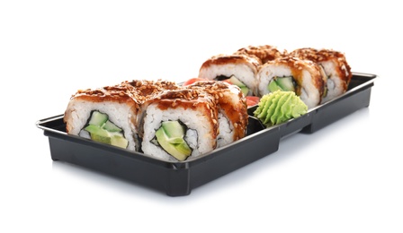 Box with tasty sushi rolls on white background. Food delivery