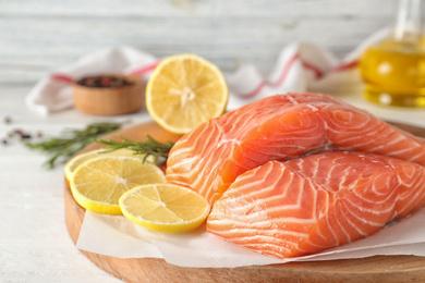 Photo of Fresh raw salmon with lemon on table. Fish delicacy