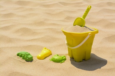 Set of colorful beach toys on sand