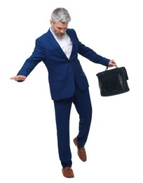 Mature businessman with briefcase posing on white background