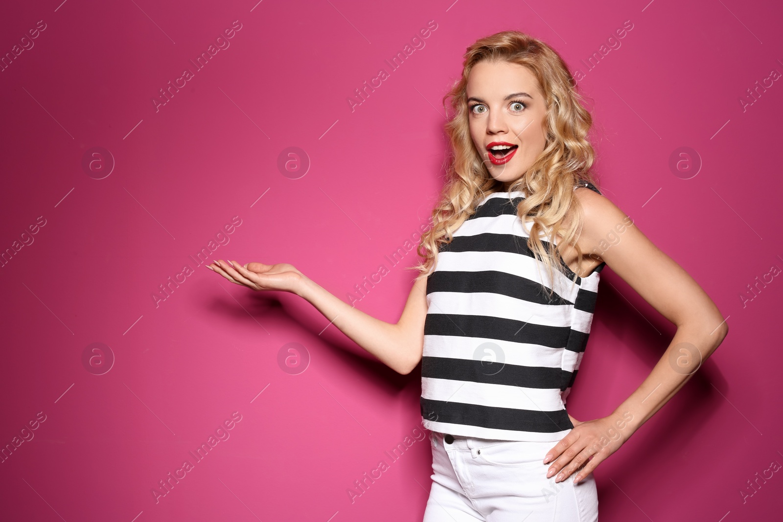 Photo of Emotional stylish young woman on color background