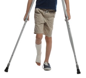 Photo of Boy with injured leg using crutches on white background, closeup