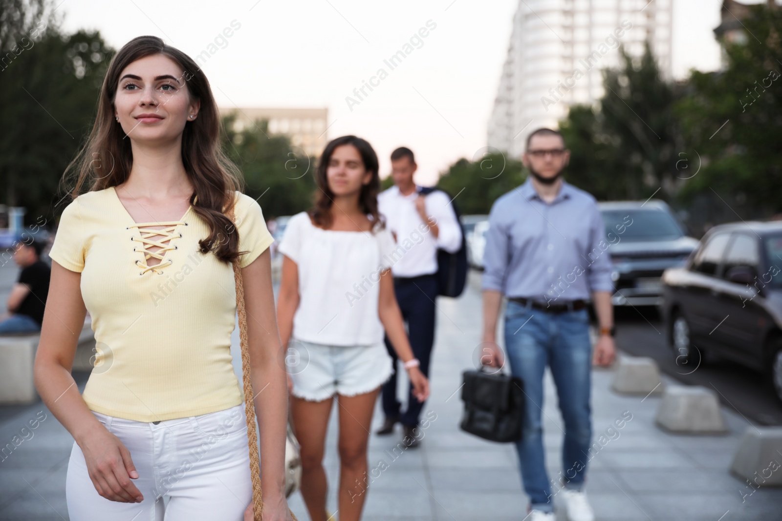 Photo of Different people walking on modern city street