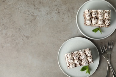 Photo of Flat lay composition with tiramisu cakes on grey table, space for text