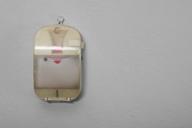 Photo of Fire alarm push button on white wall, space for text