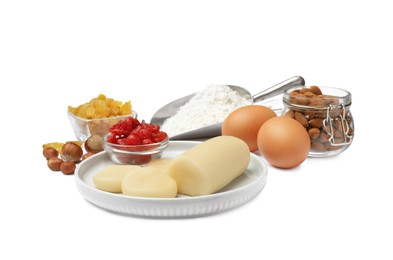 Photo of Marzipan and other ingredients for homemade Stollen on white background. Baking traditional German Christmas bread