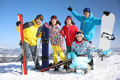 Photo of Groupfriends with equipment at ski resort. Winter vacation