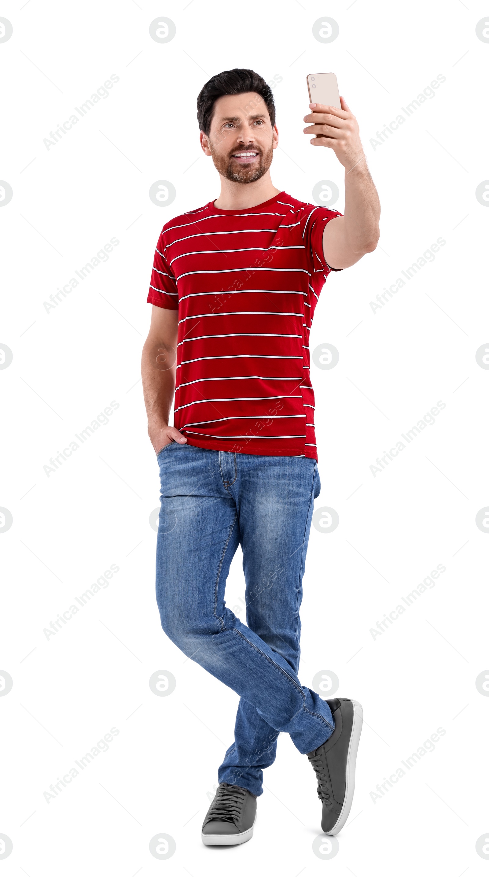 Photo of Smiling man taking selfie with smartphone on white background