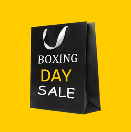 Boxing day sale. Shopping bag on yellow background